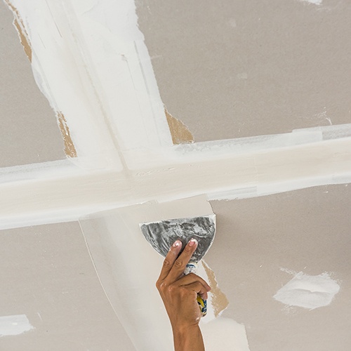 Tape and jointing compound applied to tapered edge plasterboard